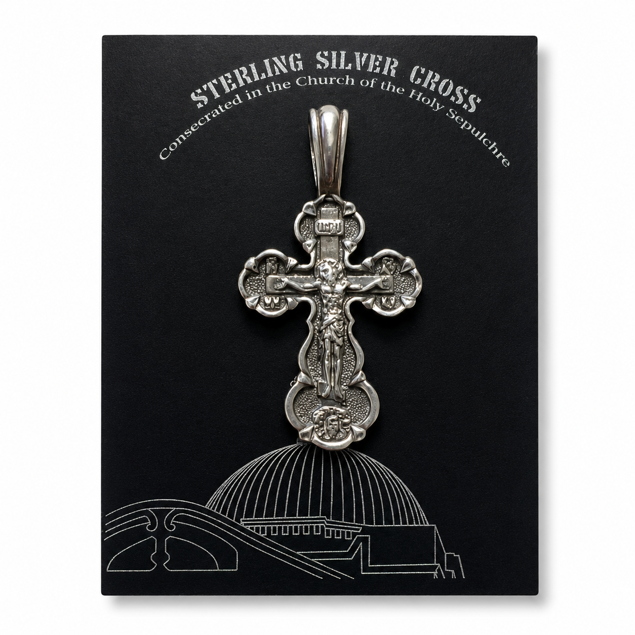 Sterling silver crucifix pendant displayed on a black card with “Sterling Silver Cross” text, Church of the Holy Sepulchre reference, INRI detail, and white architectural line art.