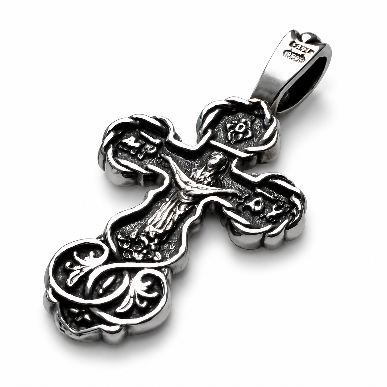 Back side angled view of an oxidized 925 sterling silver Orthodox crucifix pendant with 925 hallmark on the bail, raised scroll details, dark recessed texture, polished edges, and white background.