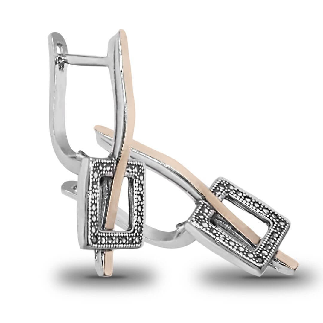 Angled display of women’s silver pendant earrings ring jewelry set
