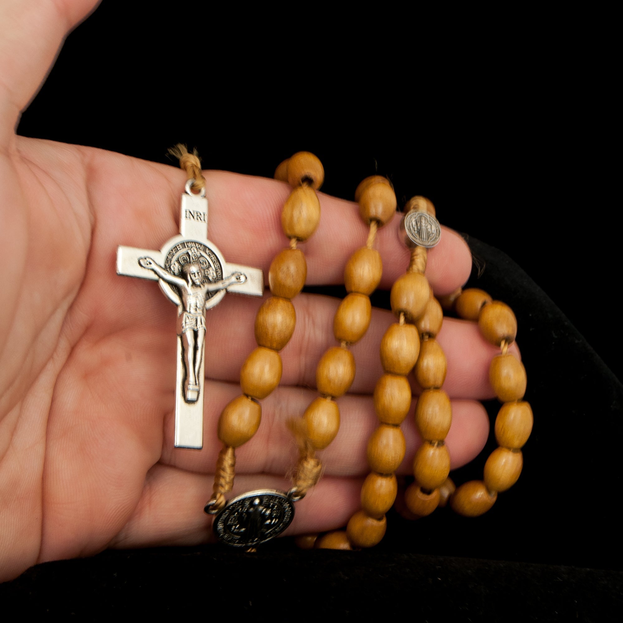 Close detail of Benedict emblem on crucifix rosary necklace
