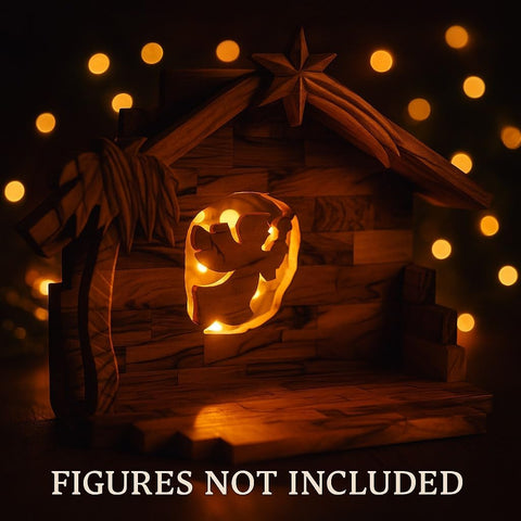 Wooden nativity scene with glowing pumpkin face in a dark setting with string lights.