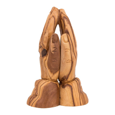 Carved praying hands figurine in natural olive wood angled perspective