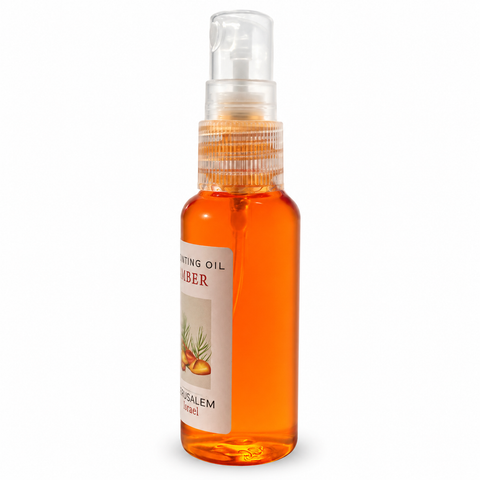 Side view of a 40ml amber anointing oil spray bottle from Jerusalem Israel featuring a clear fine mist applicator on a pure white background