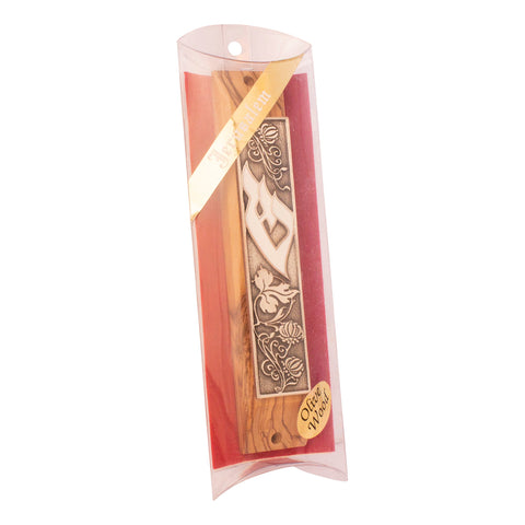Closeup carved olive wood mezuzah highlighting Shin letter
