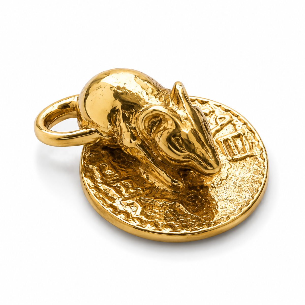 Gold pendant with a bull head design on a white background
