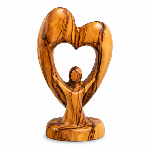 Back view of the heart-shaped wooden Holy Family sculpture, emphasizing the smooth abstract design and rich olive wood textures