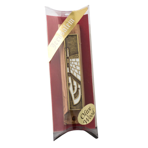 Mezuzah detail showing gold enamel and carved olive grain close-up