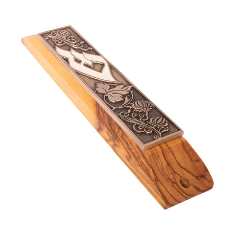 Detail of Shin enamel and scroll inside olive wood mezuzah
