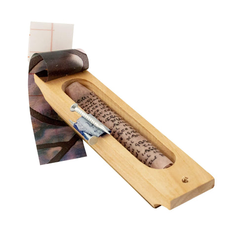Close-up mezuzah scroll detail with Ten Commandments inscription
