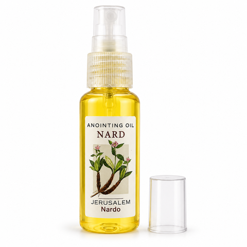 Clear spray bottle filled with yellow Nard anointing oil, white Jerusalem Nardo label with plant illustration, transparent cap beside bottle, front view on white background