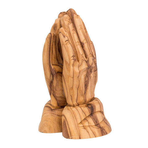 Reverse side of olive wood praying hands figurine showing natural grain