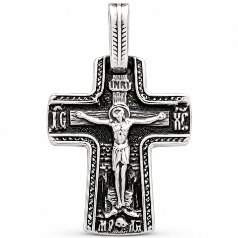 Front-view silver-tone Orthodox crucifix pendant with raised Jesus figure, dark oxidized recesses, rope-edge detailing, INRI plaque, IC XC inscriptions, and elongated bail on a white background