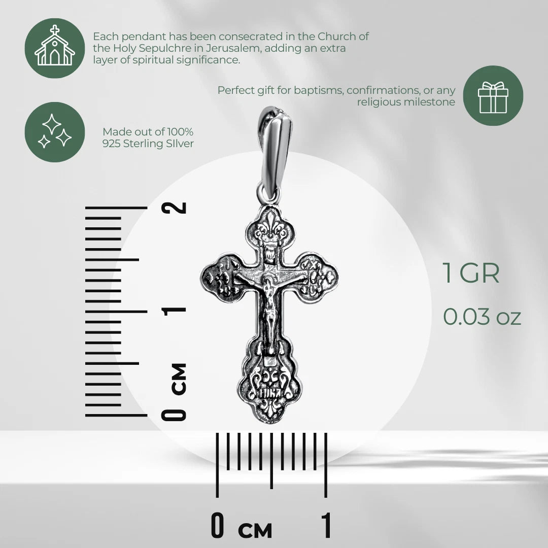 Silver crucifix pendant specification image with ruler showing 2 cm height, 1 cm width, 1 g weight, 925 sterling silver text, and green icons on gray background