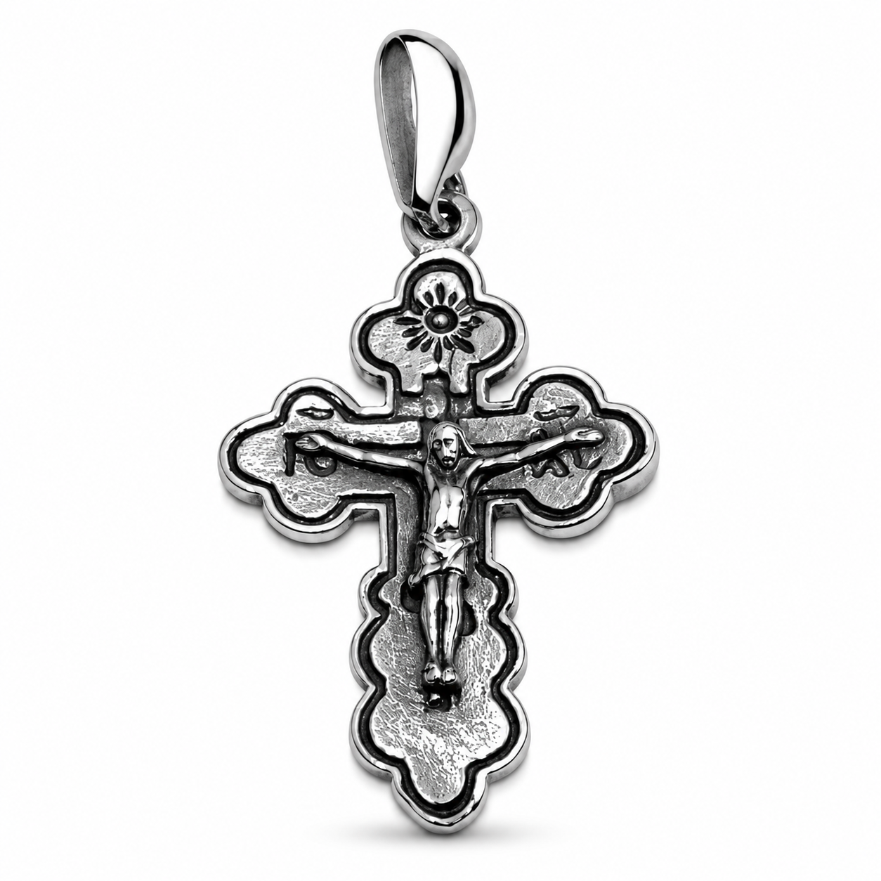 A detailed sterling silver Orthodox cross pendant with a crucifix relief of Jesus, traditional patterned trefoil ends, and a polished bail, set against a plain white background. Order this authentic Holy Land Christian gift online.