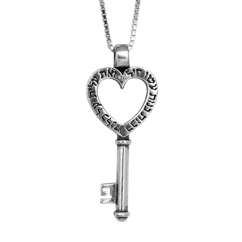 Angled front of sterling silver key pendant with engraved heart center
