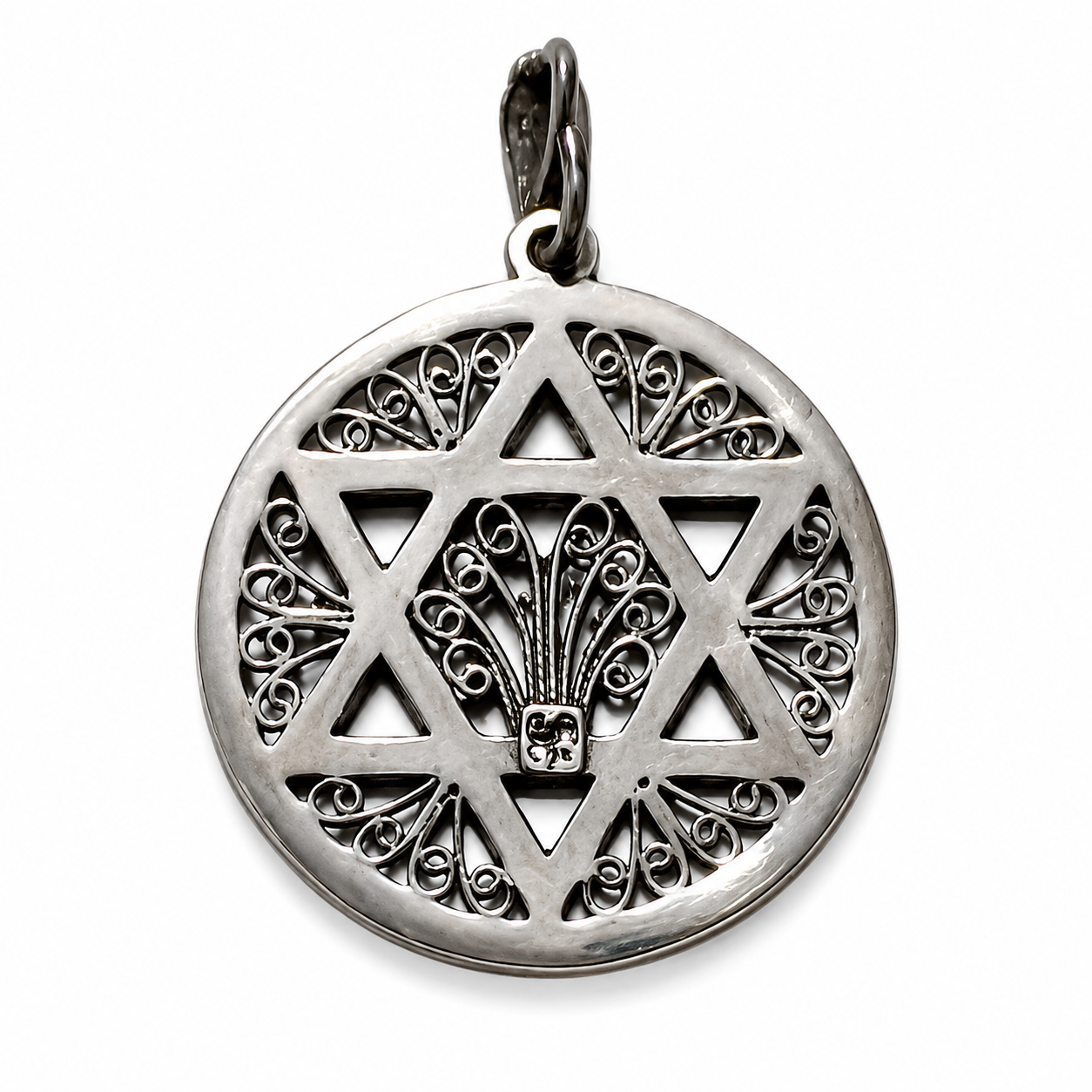 Reverse view of a round silver-tone pendant with an openwork Star of David, ornate scroll filigree, central fan-shaped motif, polished edges, dark recessed details, and a bail on a white background.