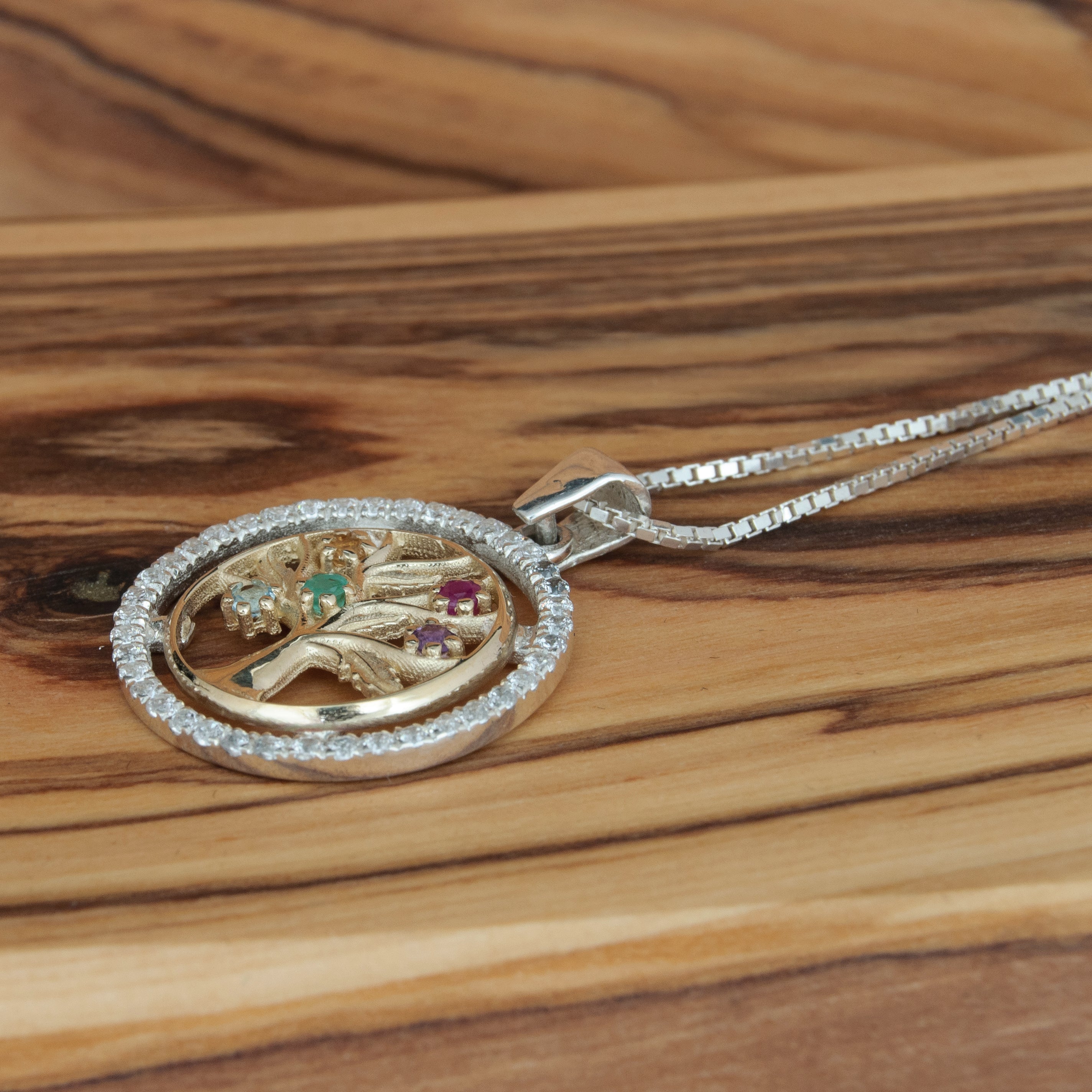 Gold and silver Tree of Life necklace showing radiant gemstone colors