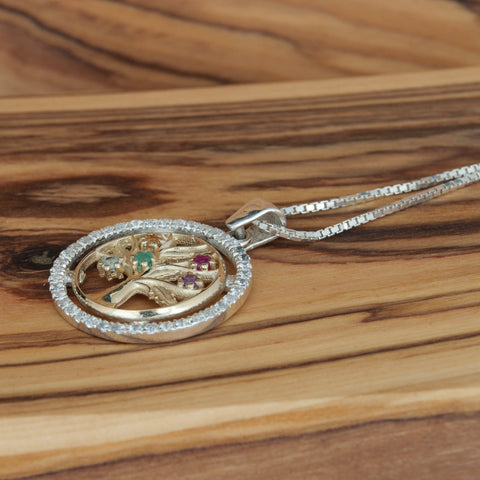 Gold and silver Tree of Life necklace showing radiant gemstone colors
